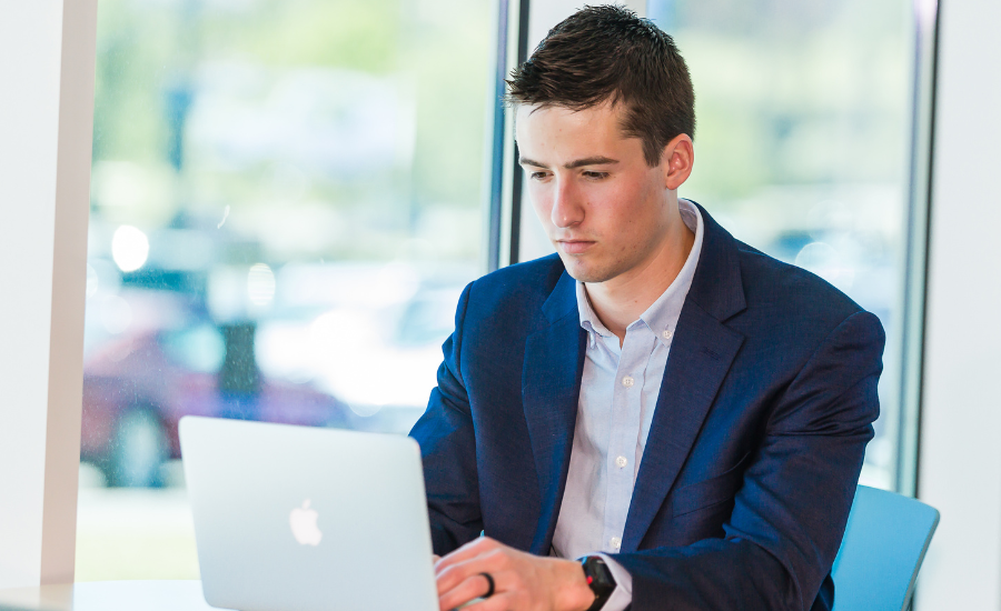 Man researching financial aid opportunities as he pursues an online degree. 